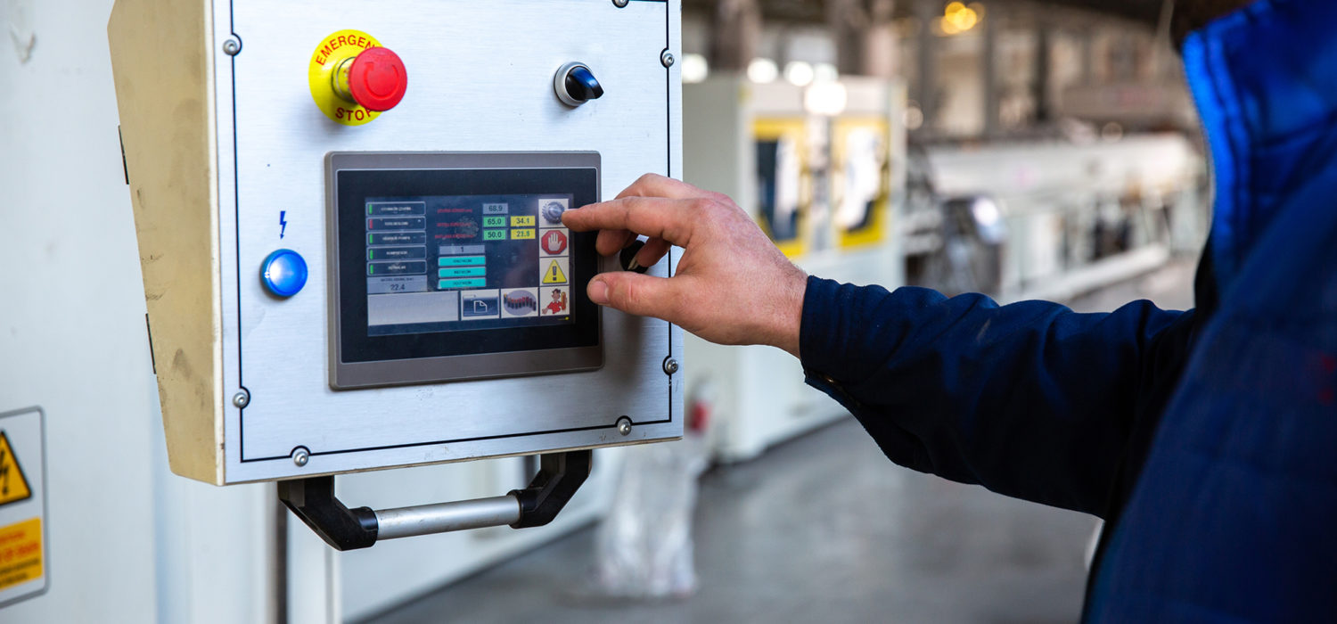 worker uses control panel in factory worker uses control panel in factory